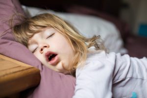 child sleeping with mouth open and snoring